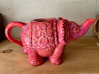 Left-side view showing handle, floral saddle detail and overall glaze