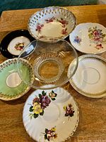 Group overview showing six saucers surrounding clear glass compote