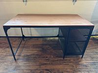 Full view of desk showing frame, mesh cabinet, tabletop