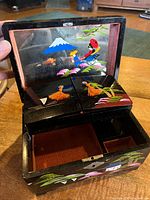 Box open showing mirror, painted dancer lids, velvet interior