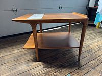 full side view showing two-tier structure, leg design, overall finish