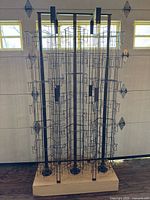 Full view of rolling card rack showing four pole structure and base