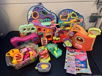 Group shot of all playsets, carrier, accessories and booklets