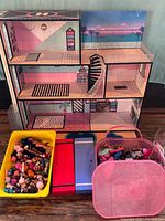 Overall lot showing dollhouse, bins and tote