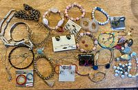 Overview of entire jewelry lot laid out on surface