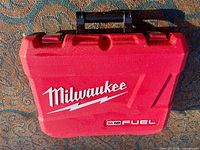 Front exterior of red Milwaukee M18 Fuel case with logo and handle