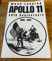Front cover showing title, anniversary years, astronaut and lunar module artwork