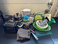 Group shot of all kitchen items including toaster, Brita pitcher, pots, utensils and boards