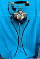 Full view of phone on brass glass stand