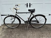 Full right-side view of entire bicycle against garage door