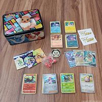 All items laid out: tin, cards, coin, dice, markers