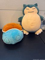 Front view of both plush toys standing upright