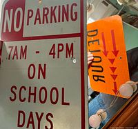 Grey "NO PARKING" side and glimpse of orange reverse in mirror