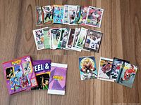 spread of assorted trading cards and Panini poster, wrappers visible