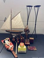 Group shot of entire lot showing sailboat, candle holders, figurine, paddle and small items