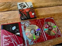 Open digipak showing two DVDs, booklet and interior artwork