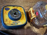 Front of VTech Kidizoom Action Cam beside waterproof case