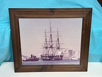 Front view of framed photograph showing ship and frame