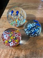 Group shot of all three blown glass paperweights
