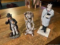 All three doctor figures standing side by side on table