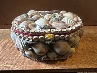 Front and top view of seashell covered jewelry box showing overall condition and shell arrangement