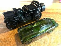 Both glass car cologne bottles side by side