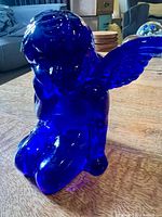 front-side view of cobalt blue glass angel candle holder kneeling