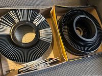 Two Kodak slide carousels in boxes with loose slides