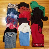 Seventeen assorted tops laid out on floor