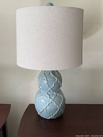 Front view of entire lamp showing base, shade, and finial