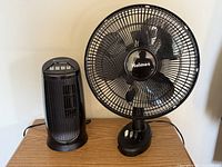 Bionaire mini tower fan and Holmes table fan side by side on desk