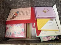 Top view of box showing various greeting card sets including bird motif card and lavender set