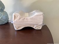 Side view showing contoured shape of pillow in clear pouch