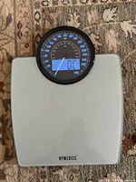 Full view of HoMedics scale showing glass platform and dial