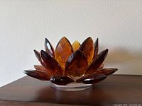 Front view showing amber faceted petals and lotus form