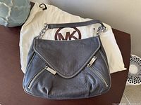 Front view of grey leather Michael Kors bag with dust bag