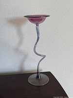 Full view of glass candlestick on table