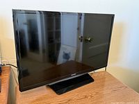 Front view of Samsung 28-inch LED TV on stand