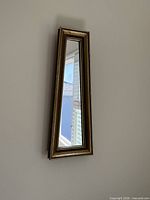 Full view of vertical tapered mirror on wall