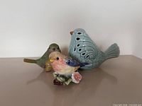 Front view of all three ceramic birds