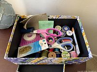 open box showing entire assortment of sewing supplies