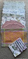 Stacked assorted vintage placemats and napkins showing each pattern