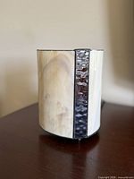 Side view of stained glass lamp showing cream glass and dark textured accent