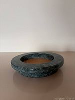 Top angled view of the green marble coaster showing cork insert