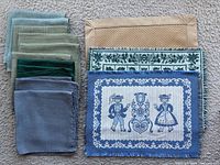 Stacked napkins in four colours and three placemats laid out