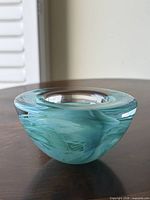 Side view of aqua blue swirl glass bowl candleholder