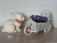 Both bunny figurines side by side on surface