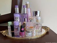 Group shot of all perfume and cosmetic bottles on tray