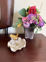 Soap dish and faux flower pot on table