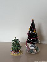Both miniature Christmas trees side by side